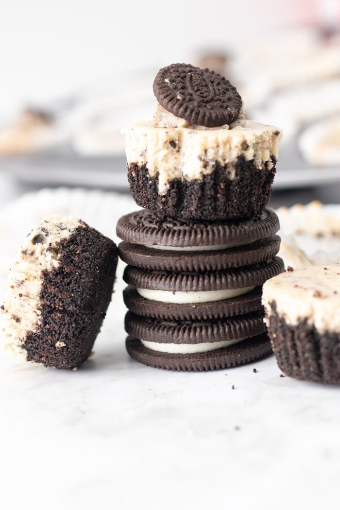 mini oreo cheesecake bite is shown on top of a stack of Oreos